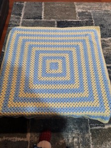Light blue and yellow granny square blanket
