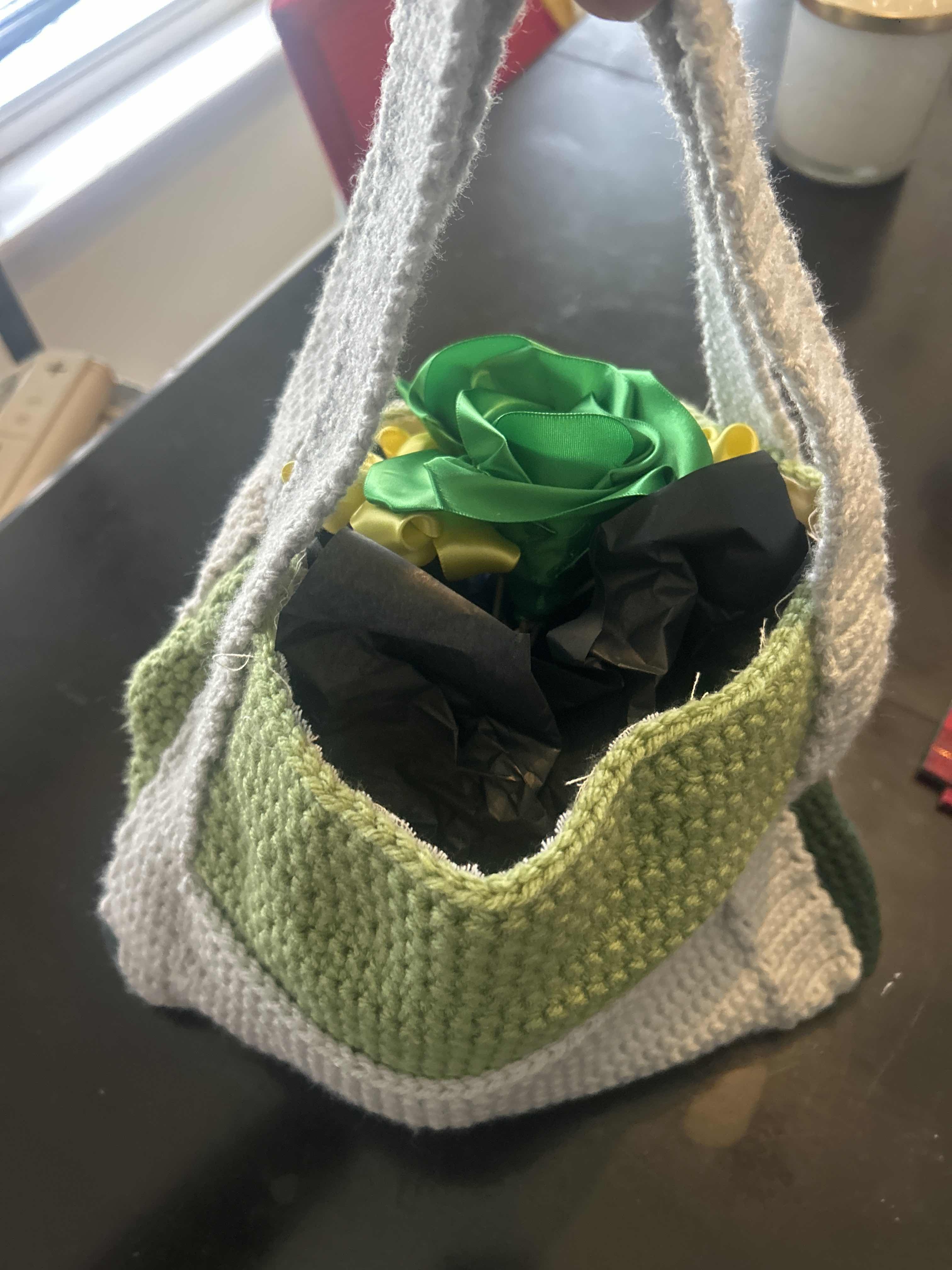 Green and grey crochet bag with flowers inside