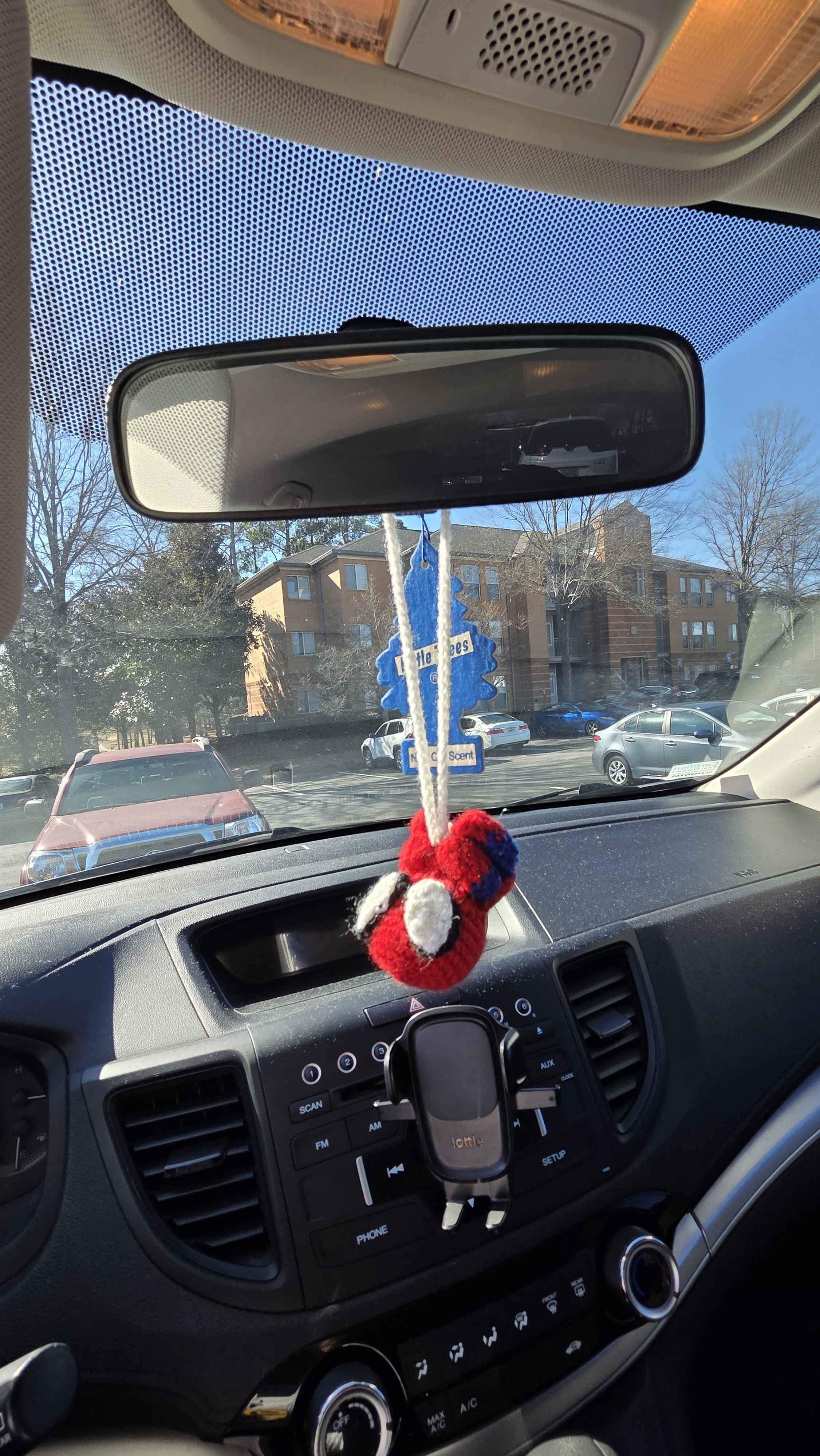 Crochet Spiderman car hanging on the middle mirror of a car