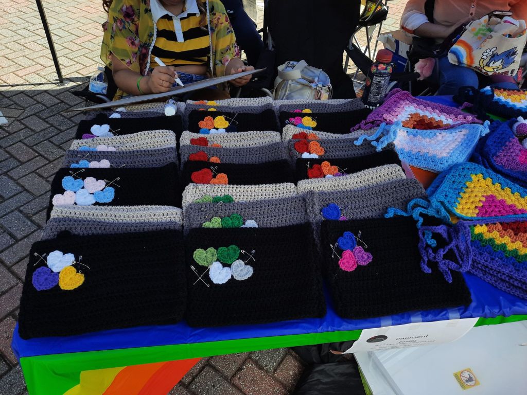 An array of colorful cat hats and a few bandanas