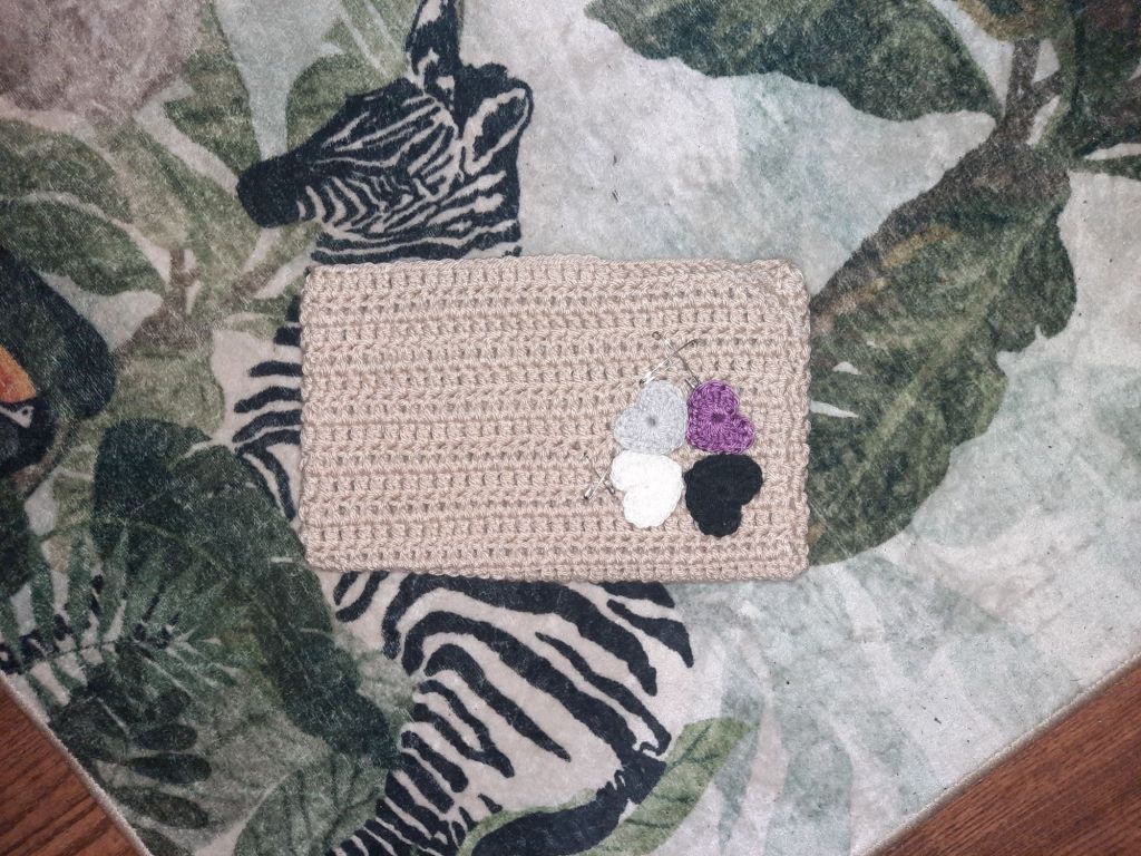 Beige cat hat with asexual colored hearts on top