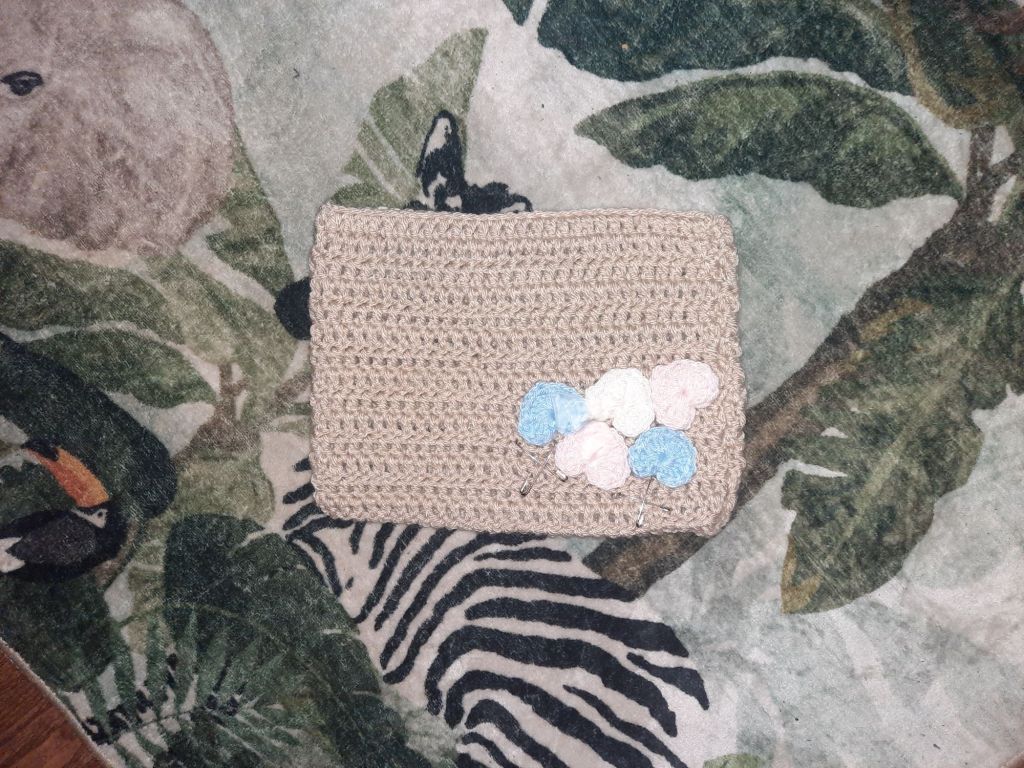 Beige cat hat with trans flag colored hearts on top