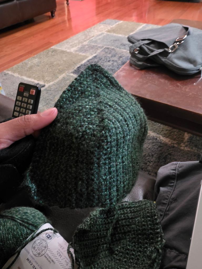 Me holding a dark green crochet shirt cup